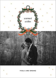 a christmas card with the words warmest wishes and an image of a couple kissing