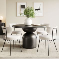 a dining room table with white chairs around it