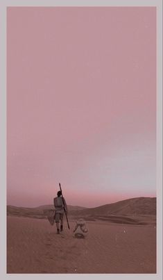 a man walking across a desert holding a surfboard