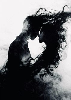 a man and woman kissing in the air with their hair blowing behind them, black and white photograph