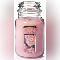 a pink yankee candle is shown in front of a white background