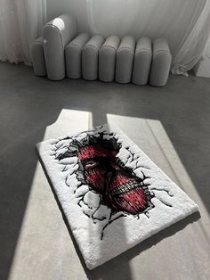 a white rug sitting on top of a floor next to a window