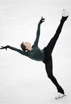 a female figure skating on an ice rink