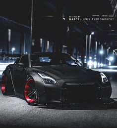 a black sports car parked on the street at night