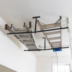 ladders are hanging from the ceiling in an empty room