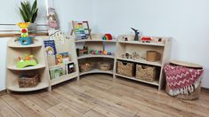 a room filled with lots of toys and bookshelves on top of wooden shelves