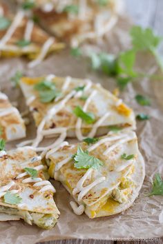 several quesadillas with cheese and cilantro sprinkled on top