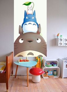 a child's room with a totoro wall mural