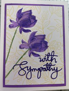 a card with purple flowers and the words, with sympathy written in cursive writing