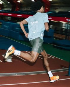 a man is running on a track in the dark