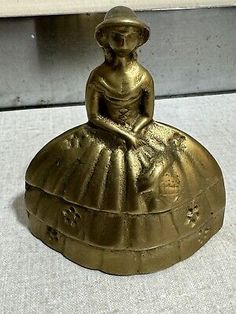 an antique brass figurine sitting on top of a box