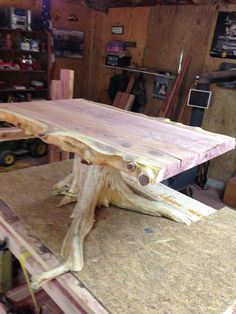 a table that is made out of wood and sitting on top of a piece of plywood