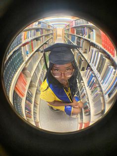 a person wearing glasses and a cap in a library