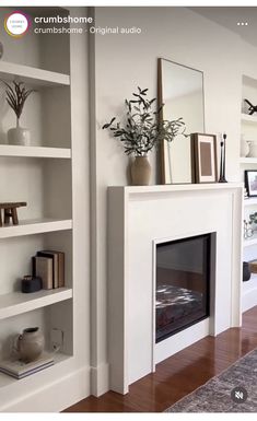 a living room with a fire place and bookshelves on the wall next to it