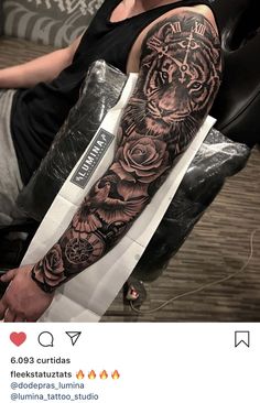 a man with a tiger tattoo on his arm