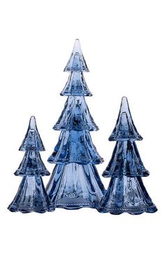 three blue glass christmas trees sitting next to each other