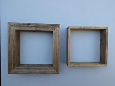 two square wooden frames hanging on the wall