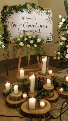 candles are arranged in front of a welcome sign