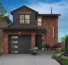 a two story brick house with black garage doors