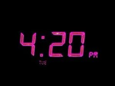 an alarm clock with the time 4 20 pm on it's display, in front of a black background