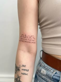 a woman with a tattoo on her arm that says,'be here now '