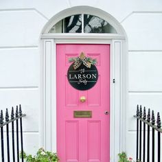 a pink front door with a welcome sign on it