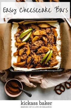 an easy cheesecake bars recipe in a baking pan with apples and cinnamon on top