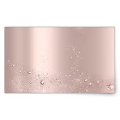 a pink metal plate with water drops on the bottom and a white wall behind it