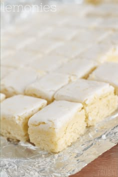 there are several pieces of cake on top of the foil wrapper that has been cut into squares