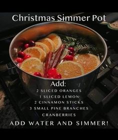 a pot filled with oranges and cranberries on top of a stove