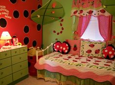 a child's bedroom decorated in green, pink and red