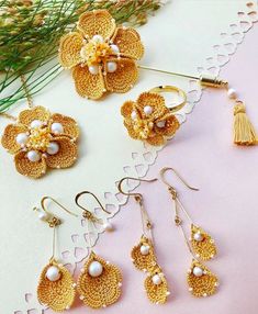 four pairs of earrings with flowers and tassels