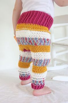 the legs of a child wearing crocheted pants