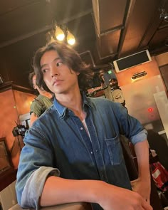 a young man sitting at a counter in a restaurant