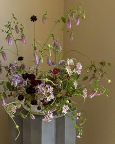 a vase filled with lots of flowers on top of a table