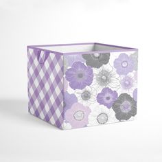 a purple and white checkered box with flowers on the front, sitting against a white background