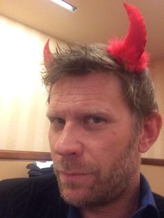 a man with red horns on top of his head