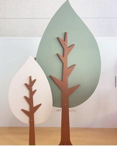 two paper cut out trees sitting next to each other