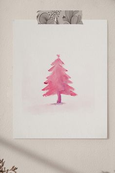 a pink christmas tree on a white wall