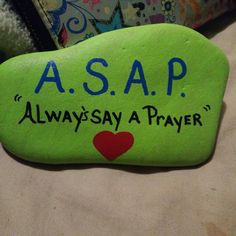 a green rock with the words asap on it and a heart painted on it