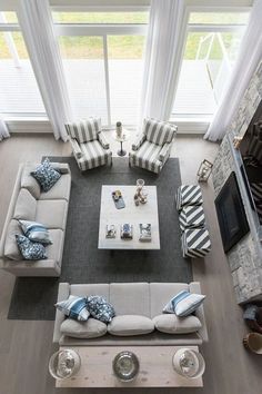 an aerial view of a living room with couches, chairs and fireplace in it