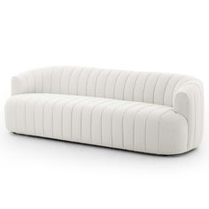 a white couch sitting on top of a white floor