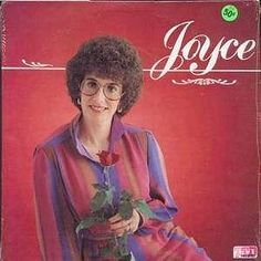 a woman holding a rose on top of a red cover with the words joyce written in white