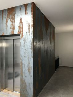 an empty room with two metal doors in it