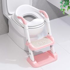 a child's potty training toilet seat with pink and white trimmings