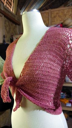 a mannequin wearing a pink knitted wrap