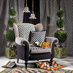 a black and white checkered wallpapered living room with an upholstered chair