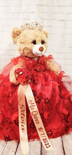 a teddy bear dressed in a red dress