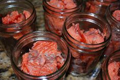 several jars filled with red food sitting on top of a counter