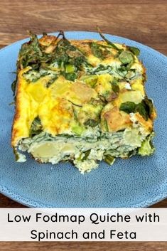 a blue plate topped with a casserole covered in spinach and feta